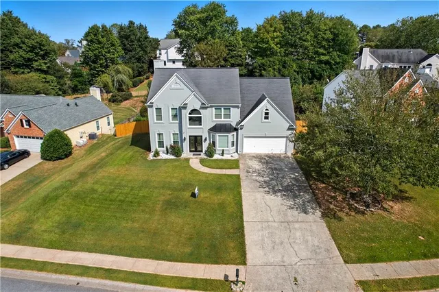a aerial view of a house with a yard