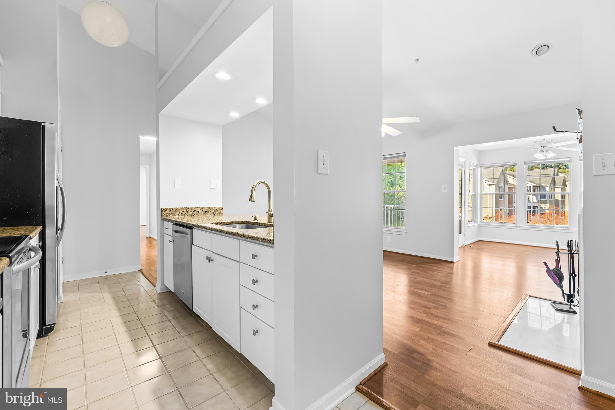 a kitchen with granite countertop a stove and a sink