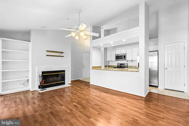 a view of a room with kitchen and fireplace