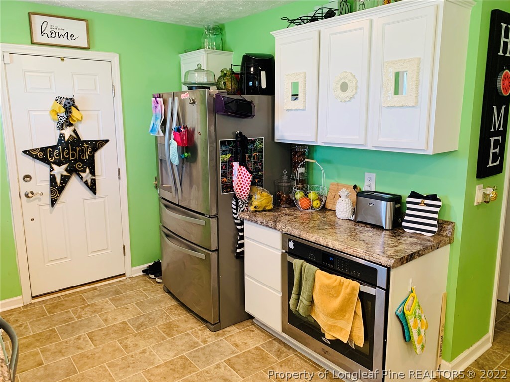 1000 Rowan Road Lumberton, NC 28358 - Photo 13 of 41 a kitchen with stainless steel appliances granite countertop a refrigerator and a stove