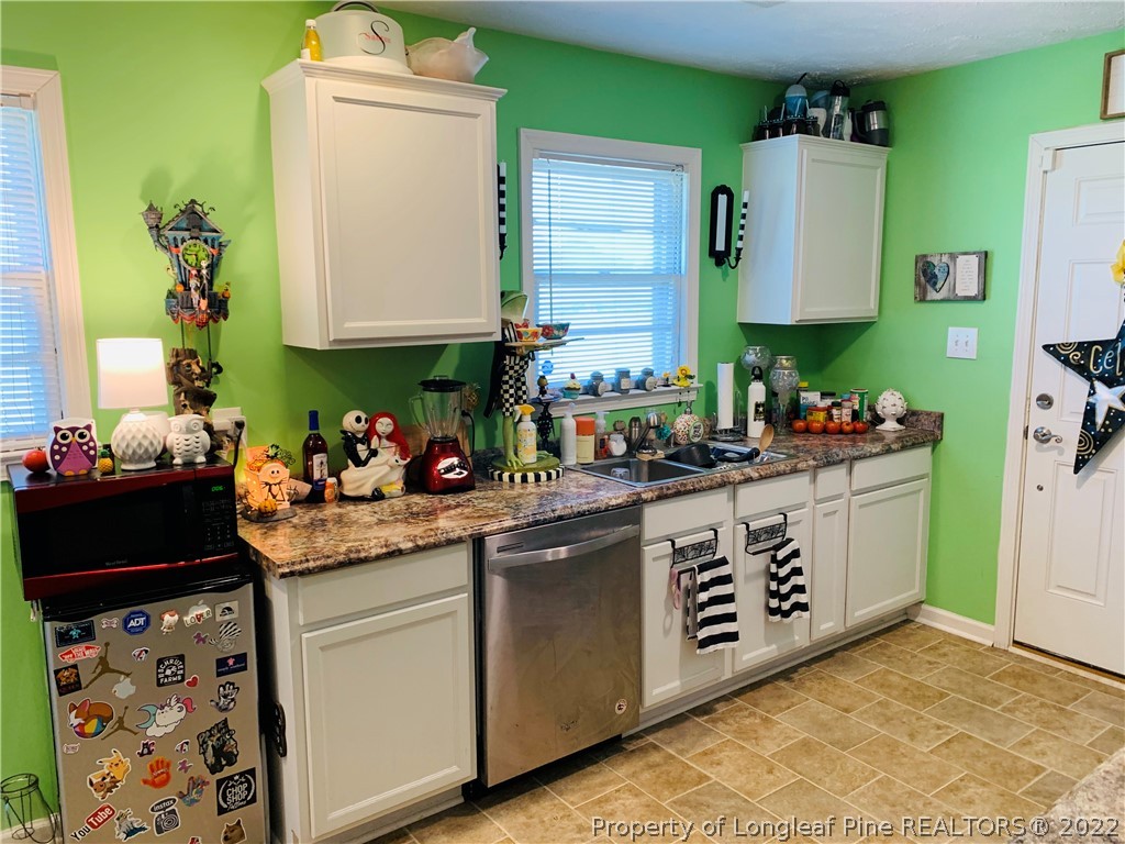 1000 Rowan Road Lumberton, NC 28358 - Photo 14 of 41 a kitchen with stainless steel appliances granite countertop a sink stove and cabinets
