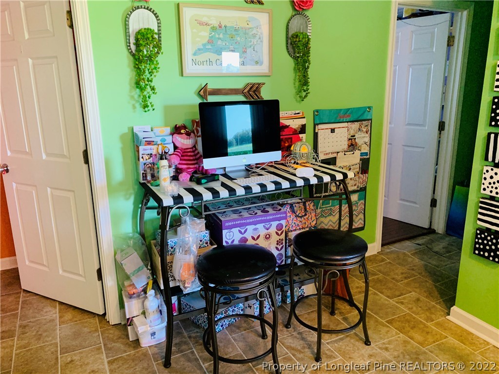 1000 Rowan Road Lumberton, NC 28358 - Photo 15 of 41 a table chair in a work room with wooden floor