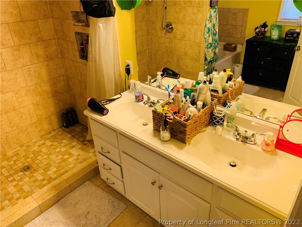 1000 Rowan Road Lumberton, NC 28358 - Photo 24 of 41 a bathroom with a sink and a mirror