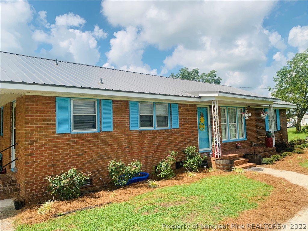 1000 Rowan Road Lumberton, NC 28358 - Photo 3 of 41 a front view of a house with a yard