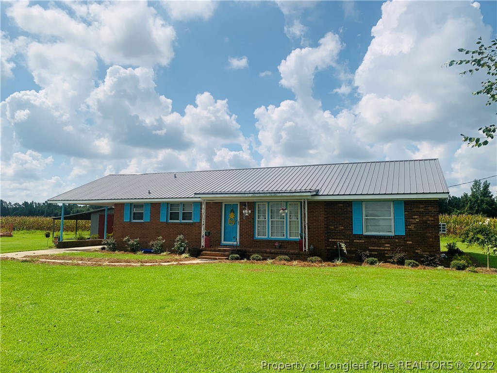 1000 Rowan Road Lumberton, NC 28358 - Photo 37 of 41 a front view of a house with a garden