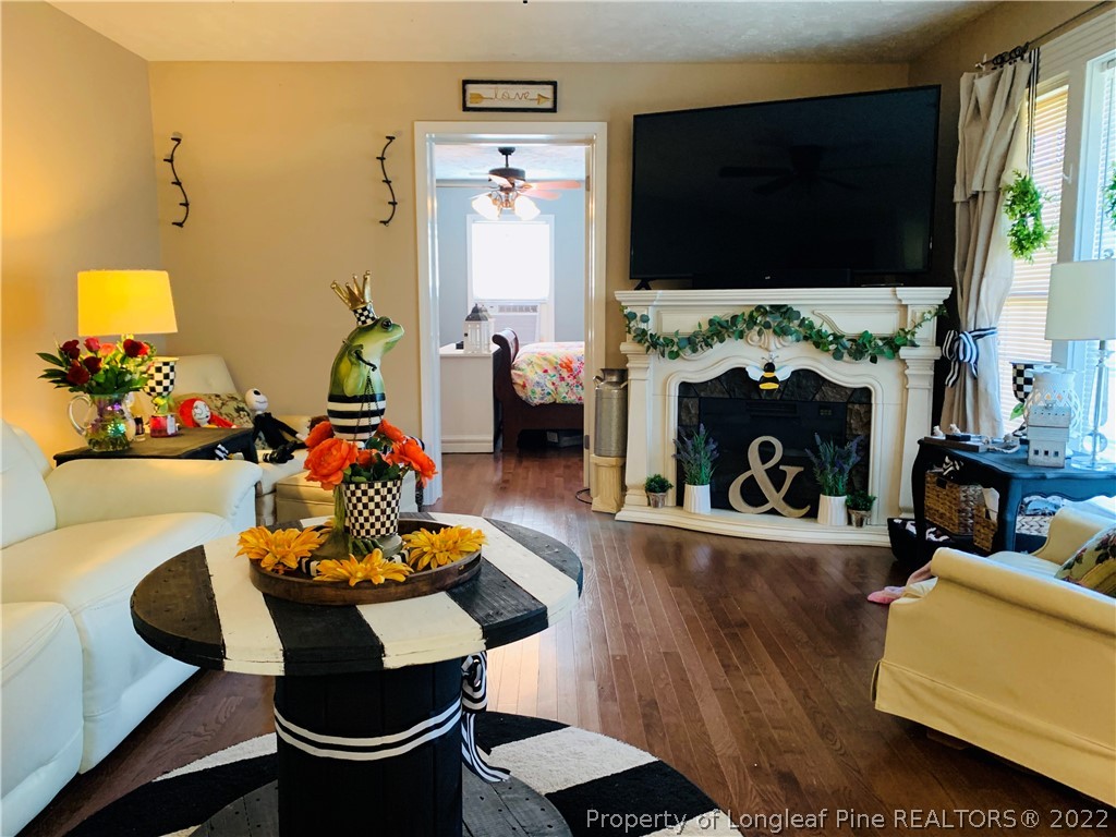 1000 Rowan Road Lumberton, NC 28358 - Photo 5 of 41 a living room with furniture a flat screen tv and a fireplace