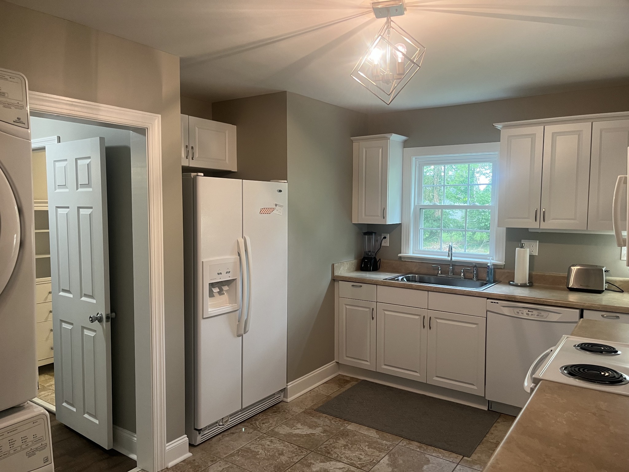 107 West Songer Street Waynesboro, TN 38485 - Photo 15 of 26 a kitchen with a sink a refrigerator and cabinets