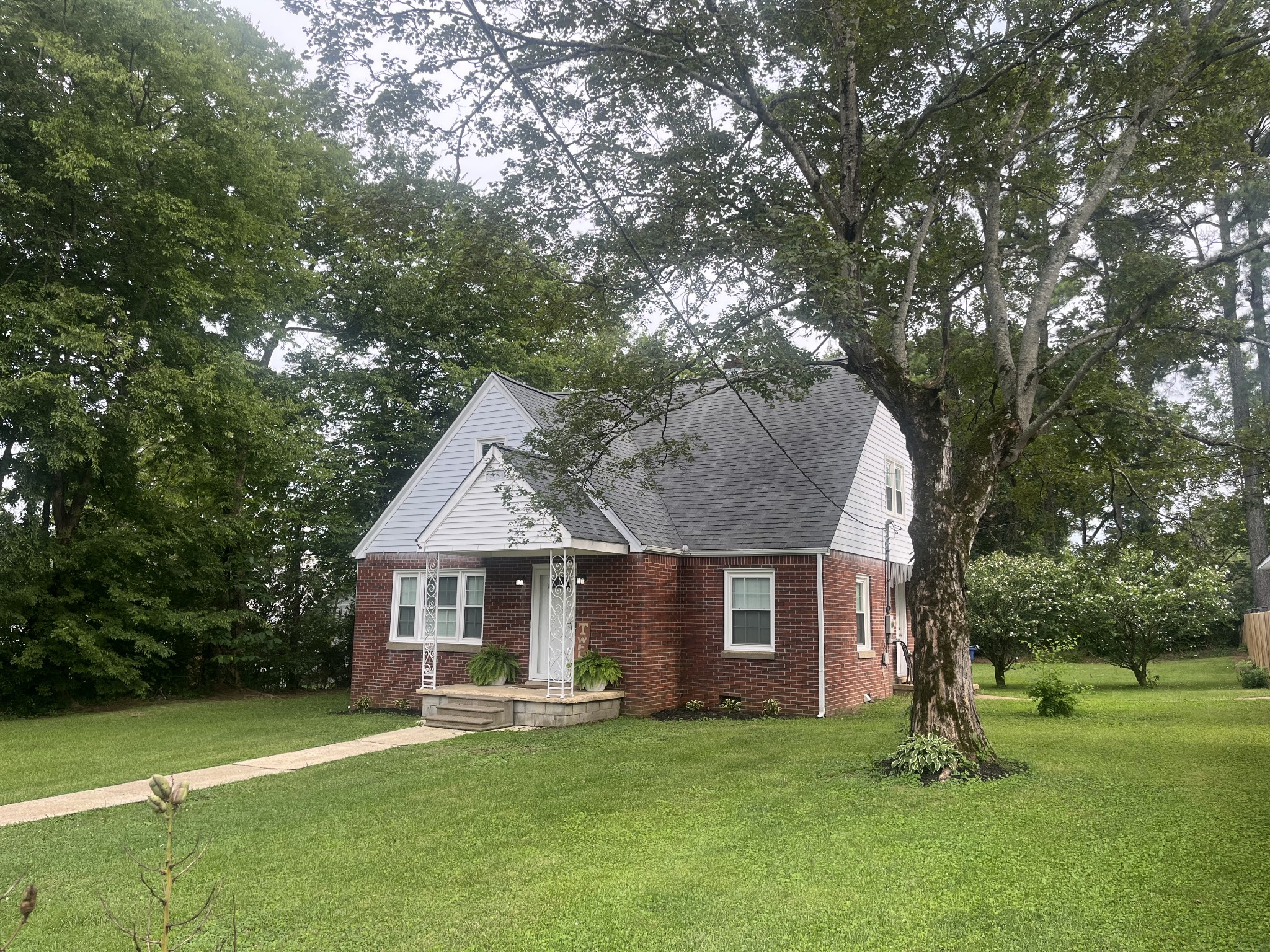 107 West Songer Street Waynesboro, TN 38485 - Photo 5 of 26 a front view of a house with a garden and trees
