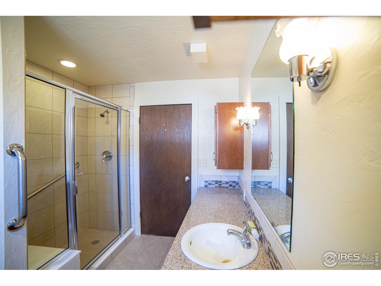 37797 Poudre Canyon Road Bellvue, CO 80512 - Photo 15 of 15 a bathroom with a sink and mirror