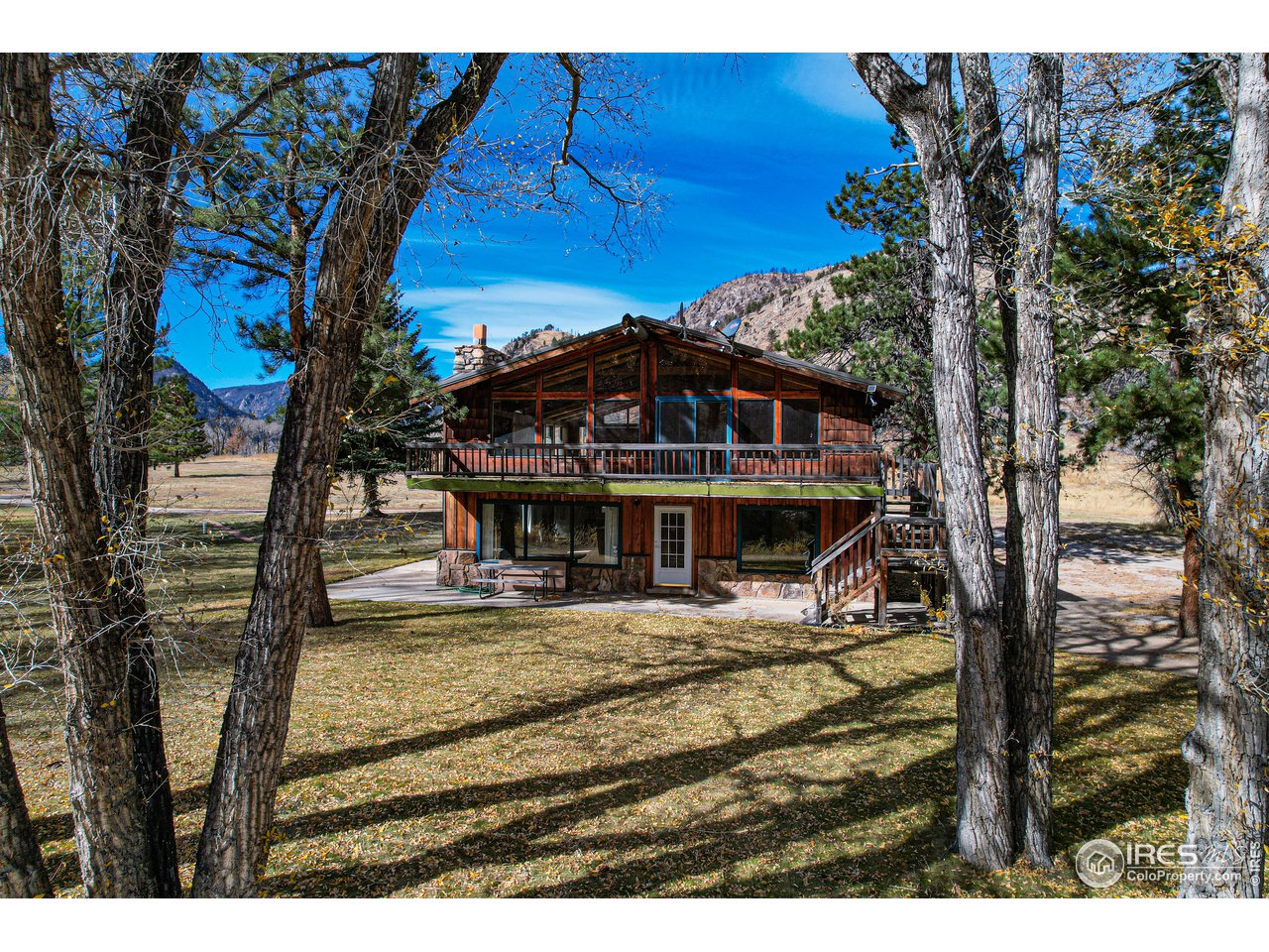 37797 Poudre Canyon Road Bellvue, CO 80512 - Photo 2 of 15 a view of a house with a yard