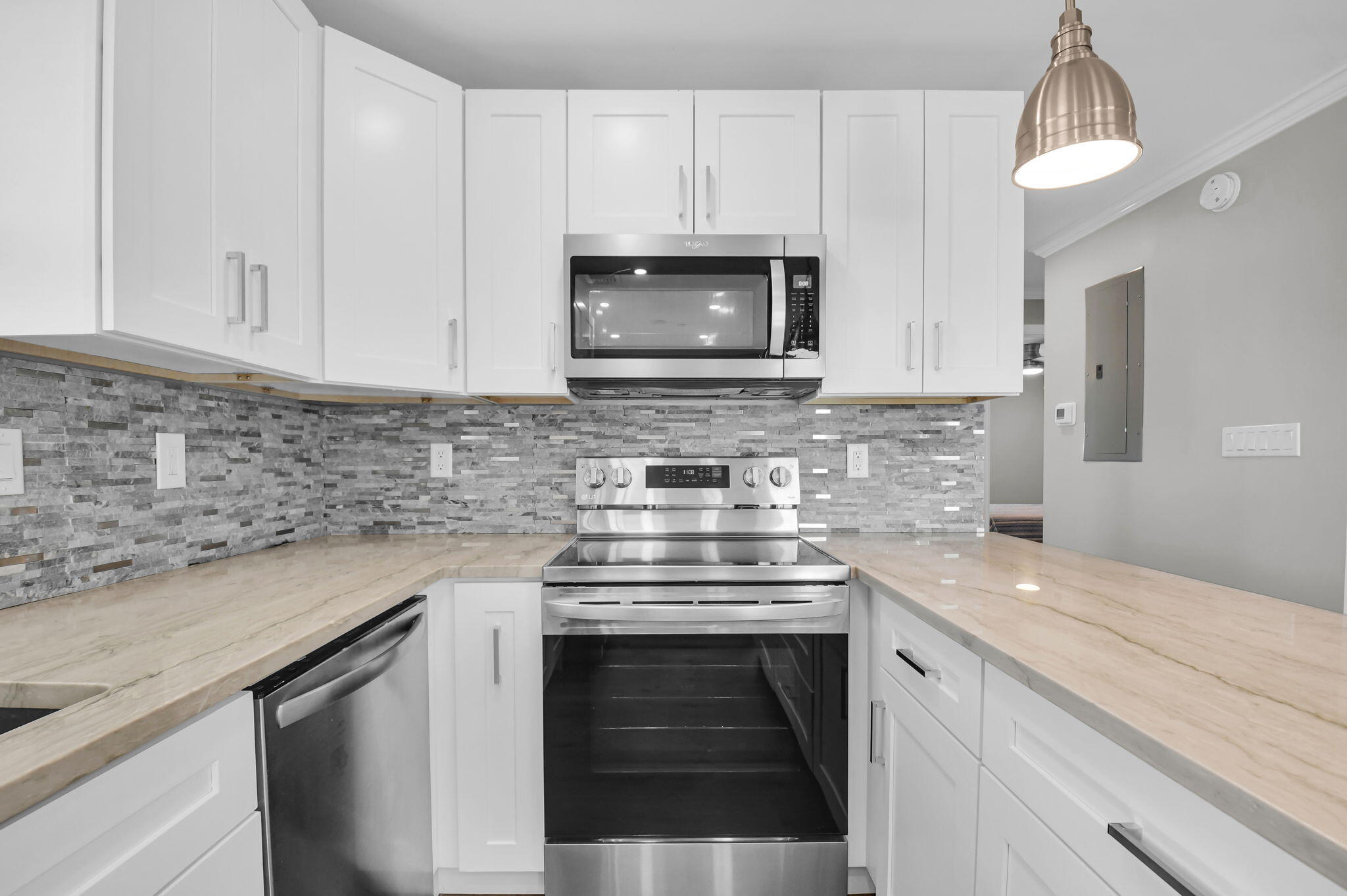 388 Tuscany Lane, Unit 388 Delray Beach, FL 33446 - Photo 11 of 40 a kitchen with cabinets stainless steel appliances a sink and a stove