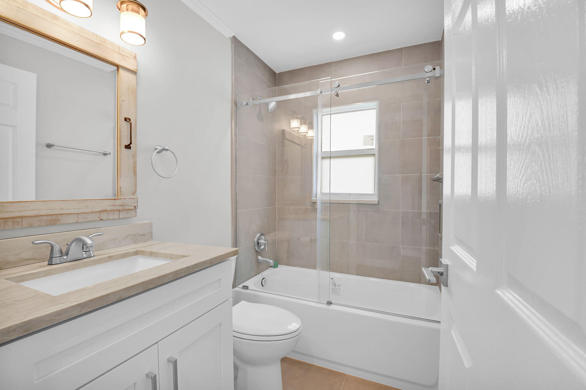 388 Tuscany Lane, Unit 388 Delray Beach, FL 33446 - Photo 17 of 40 a bathroom with a sink a toilet and shower