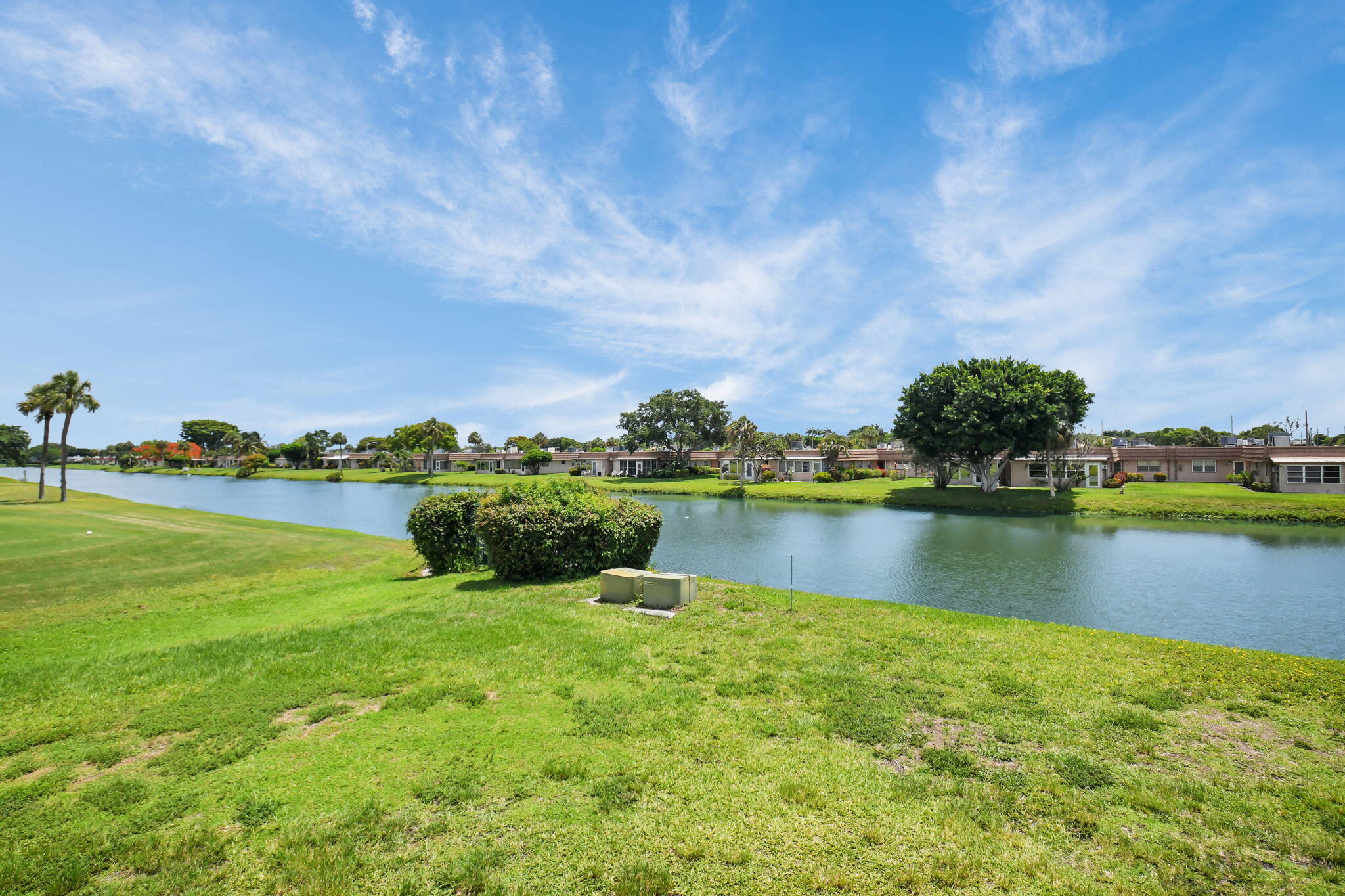 388 Tuscany Lane, Unit 388 Delray Beach, FL 33446 - Photo 2 of 40 a view of a lake with houses in the back