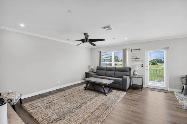 a living room with furniture and wooden floor