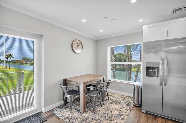 a dining room with furniture and a window