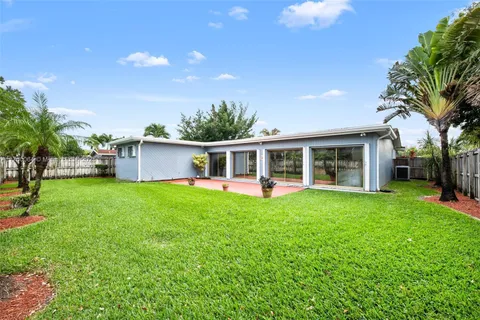 a front view of house with yard and outdoor seating