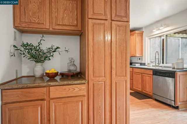 a kitchen with stainless steel appliances granite countertop a refrigerator and a sink