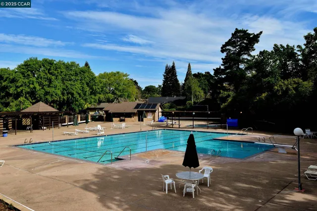 a swimming pool with outdoor seating