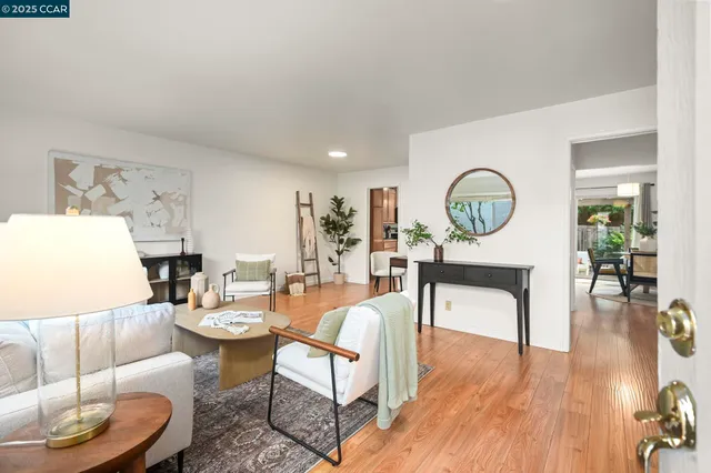 a living room with fireplace furniture and a wooden floor