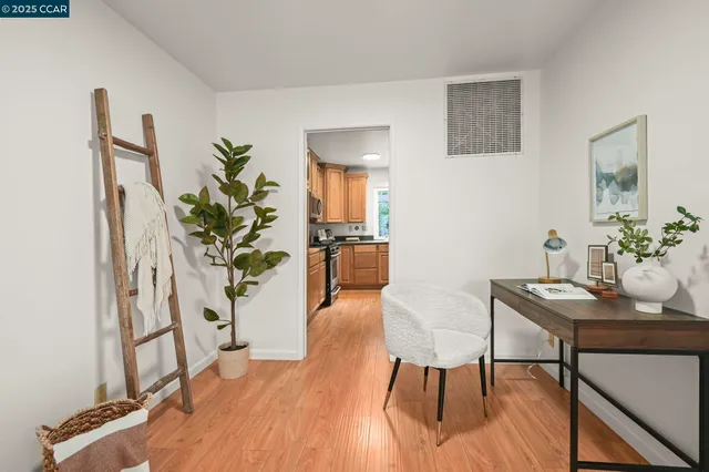 a view of a dining room with furniture and a potted plant