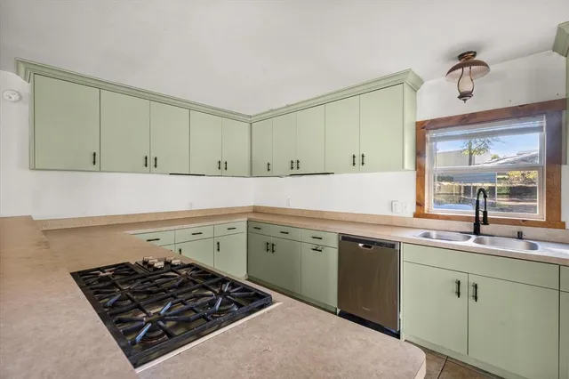 a kitchen with a sink stove and cabinets