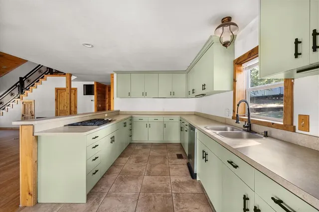 a kitchen with a sink stove and cabinets