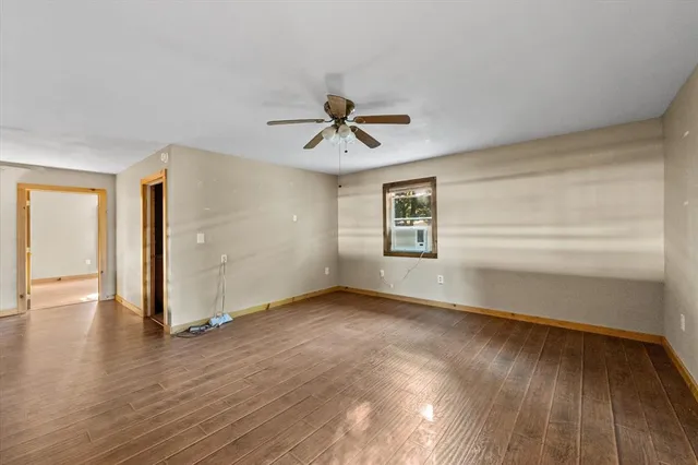 wooden floor in an empty room with a window
