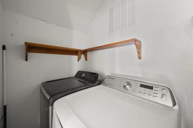 a close up of a utility room with dryer and washer