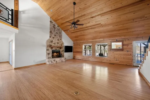a view of a livingroom with wooden floor and a ceiling fan