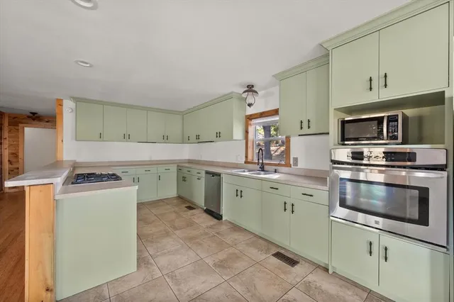 a kitchen with a sink stove and microwave