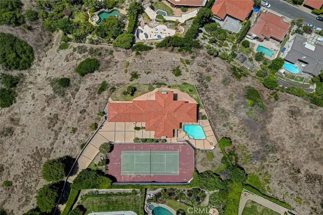 an aerial view of a house with a garden and trees