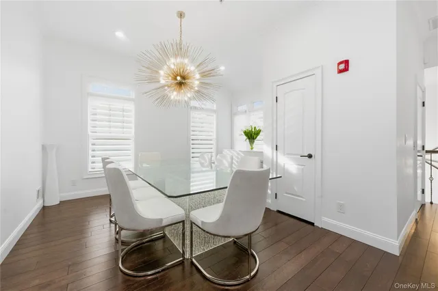 a view of a dining room with furniture and chandelier