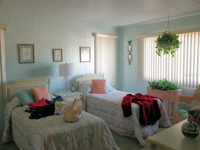 a bedroom with bed and a window