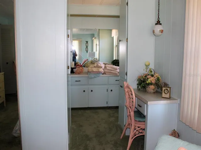 a bathroom with a sink mirror and toilet