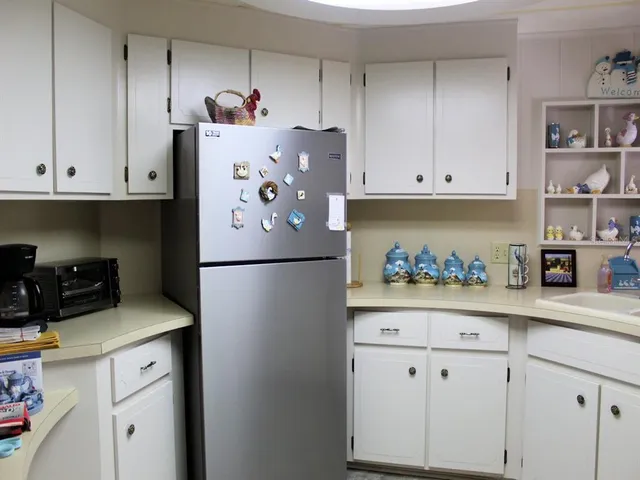 a white refrigerator freezer sitting in a kitchen