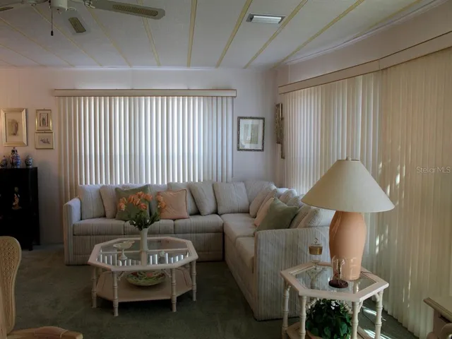 a living room with furniture and a lamp