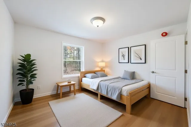 a bedroom with a bed and a potted plant