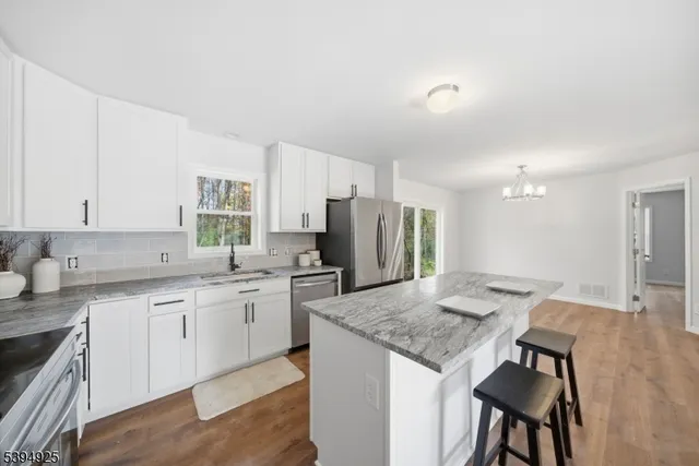 a kitchen with center island and stainless steel appliances
