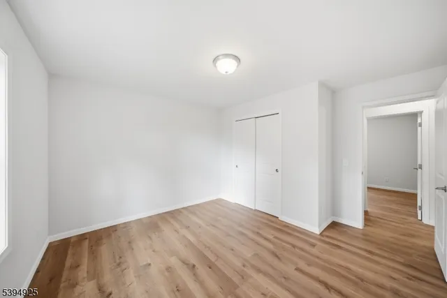 a view of a room with wooden floor and brick wall