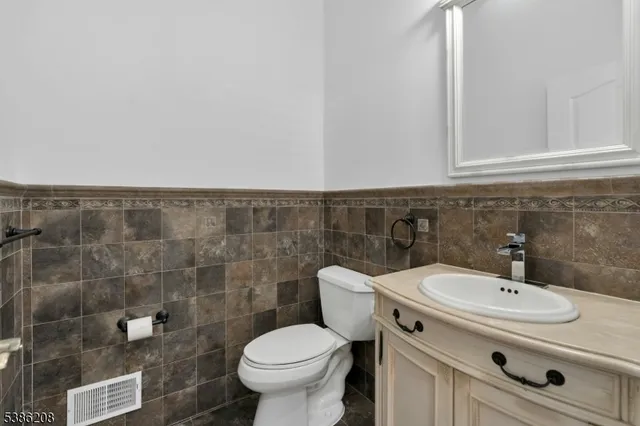 a bathroom with a sink toilet and a mirror