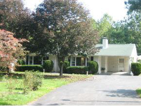 a front view of house with yard and green space