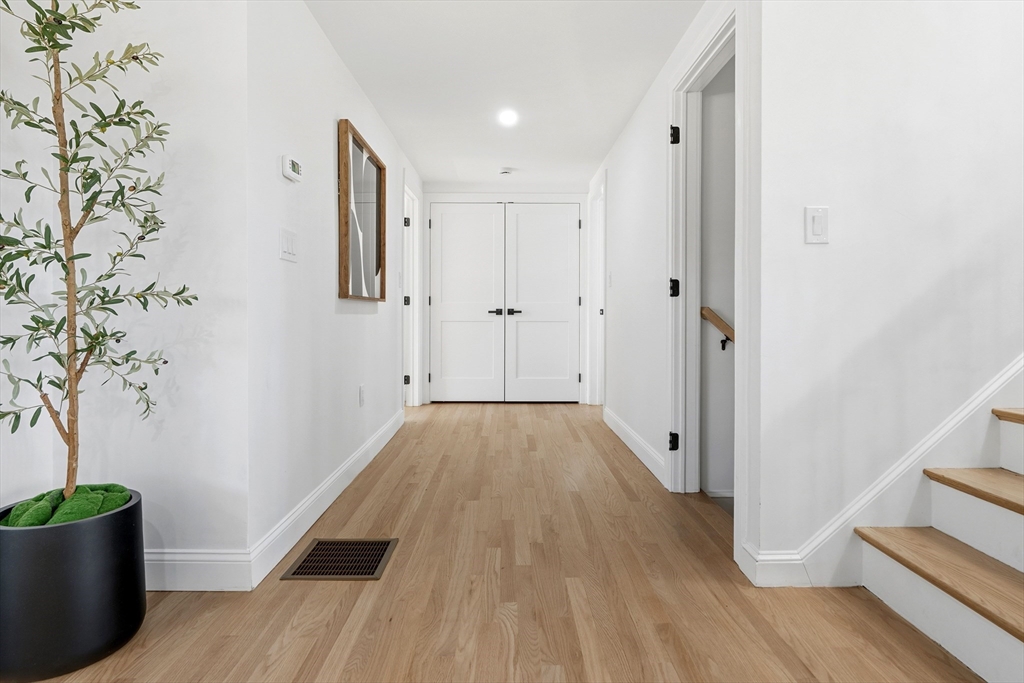 171 Shaw Road Brookline, MA 02467 - Photo 13 of 42 a view of a hallway with wooden floor and entryway