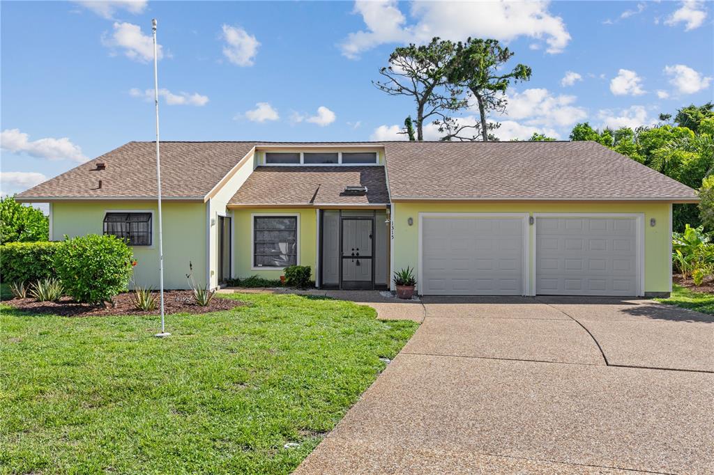 1315 Pine Needle Road Venice, FL 34285 - Photo 1 of 52 a front view of a house with a garden and yard