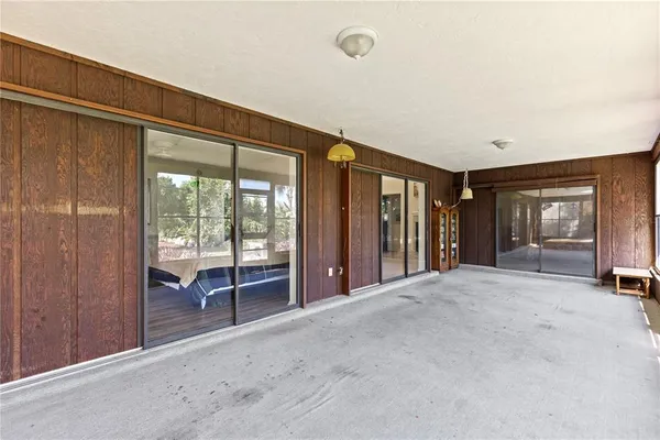 a view of a room with a large window and bathroom
