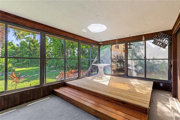 a view of a room with wooden floor and windows