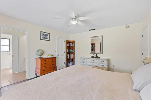 a bedroom with a large bed and dresser