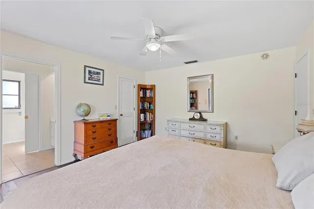 a bedroom with a large bed and dresser
