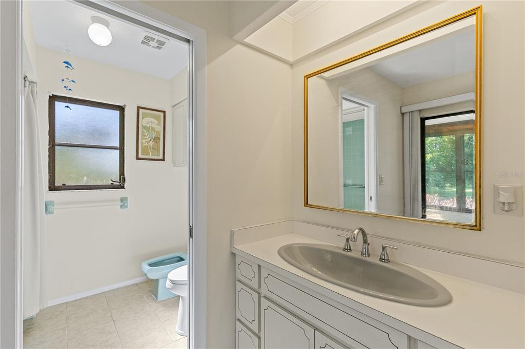 1315 Pine Needle Road Venice, FL 34285 - Photo 21 of 52 a bathroom with a toilet sink and mirror