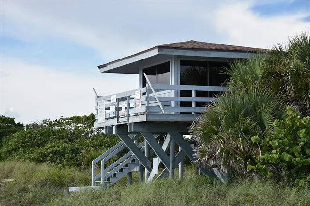 a view of house with roof deck and entertaining space
