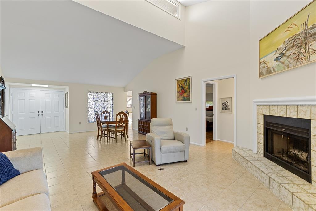 1315 Pine Needle Road Venice, FL 34285 - Photo 5 of 52 a living room with furniture and a fireplace